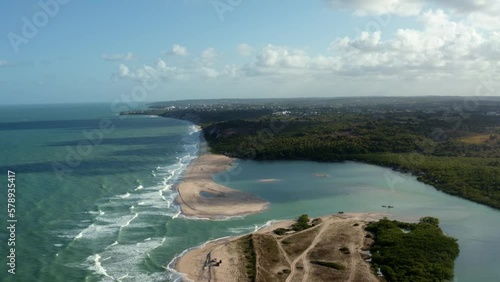 Aerial drone wide shot of the beautiful coastline of Gramame where the ocean meets the river near the tropical beach capital city of Joao Pessoa in Paraiba, Brazil on a warm summer day. photo