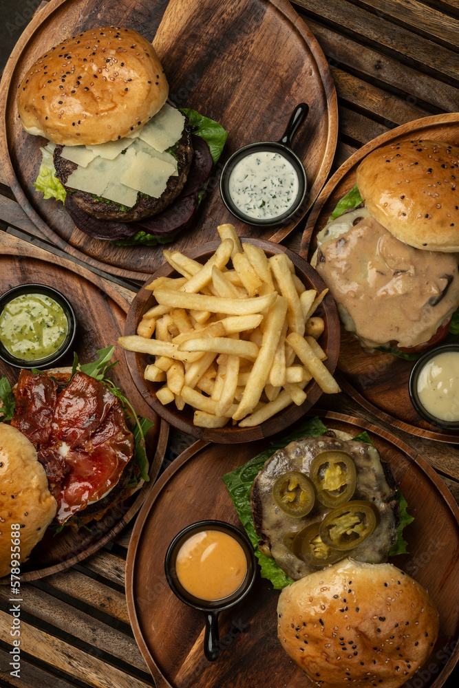 many different gourmet burgers selection on wood table