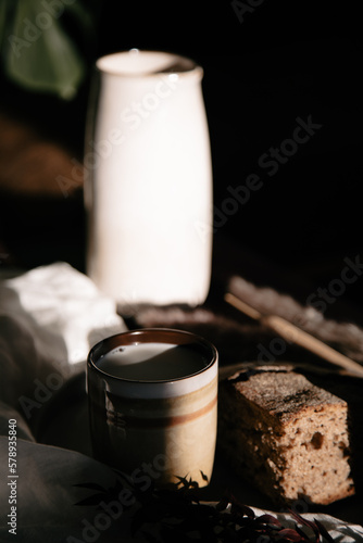 morning coffee latte with bread in the warm light of the window