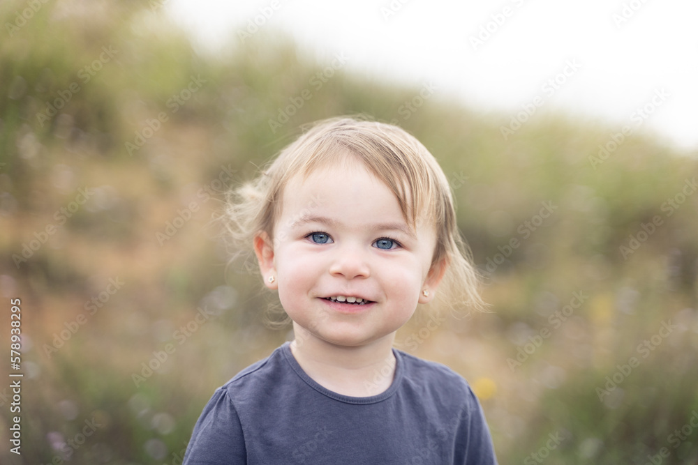 Cute little girl looking at camera outdoors Cute little girl looking at camera outdoors