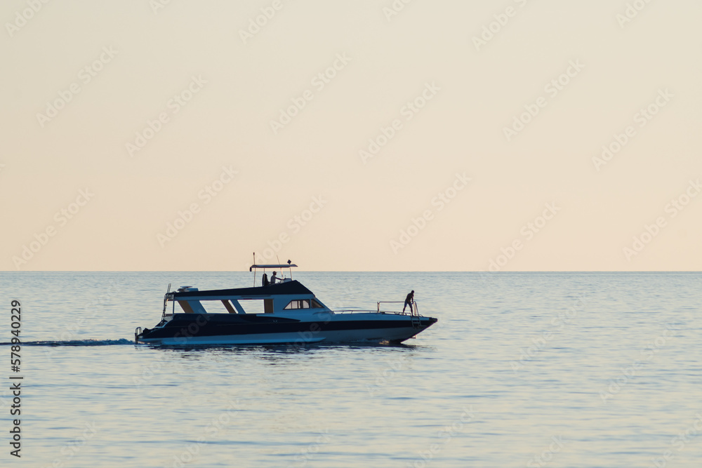 Silhouette of a boat on the open sea