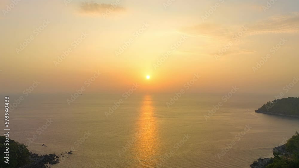 aerial hyperlapse lapse view golden sky in sunset above the freedom beach Patong Phuket..smooth cloudy sky at sunset at freedom beach. Gradient color. .Sky texture, abstract nature background. aerial hyperlapse lapse view golden sky in sunset above the freedom beach Patong Phuket..smooth cloudy sky at sunset at freedom beach. Gradient color. .Sky texture, abstract nature background.