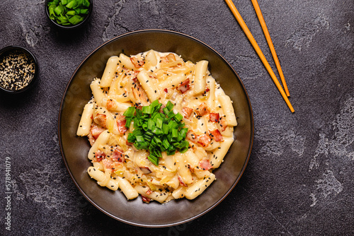 Spicy Rice Cake with Cheese and Bacon or Cream Teokbokki, Tteokbokki. photo