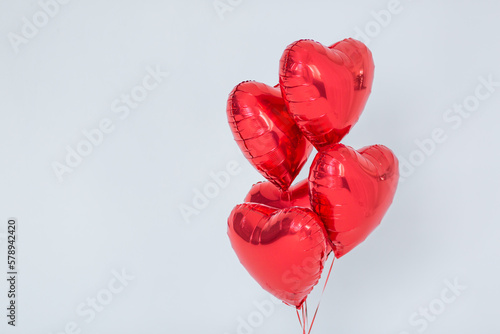 Red balloons in the form of hearts on a white background.