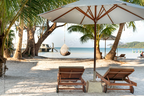 The sun loungers under umbrellas on the sandy beach on paradise island Villa Koh Rong Samloem. Cambodia. This is a small island that