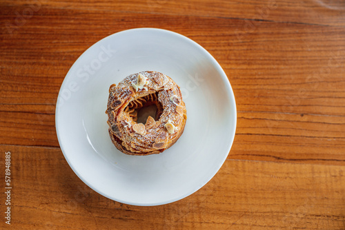 Top view of French pastry Paris Brest on a white plate