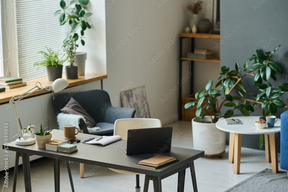 Horizontal image of modern workplace with laptop for remote work in the living room at home Horizontal image of modern workplace with laptop for remote work in the living room at home