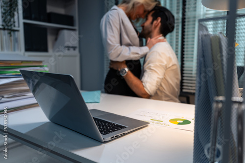Caucasian businessman and woman foreplay and making love in the office. 