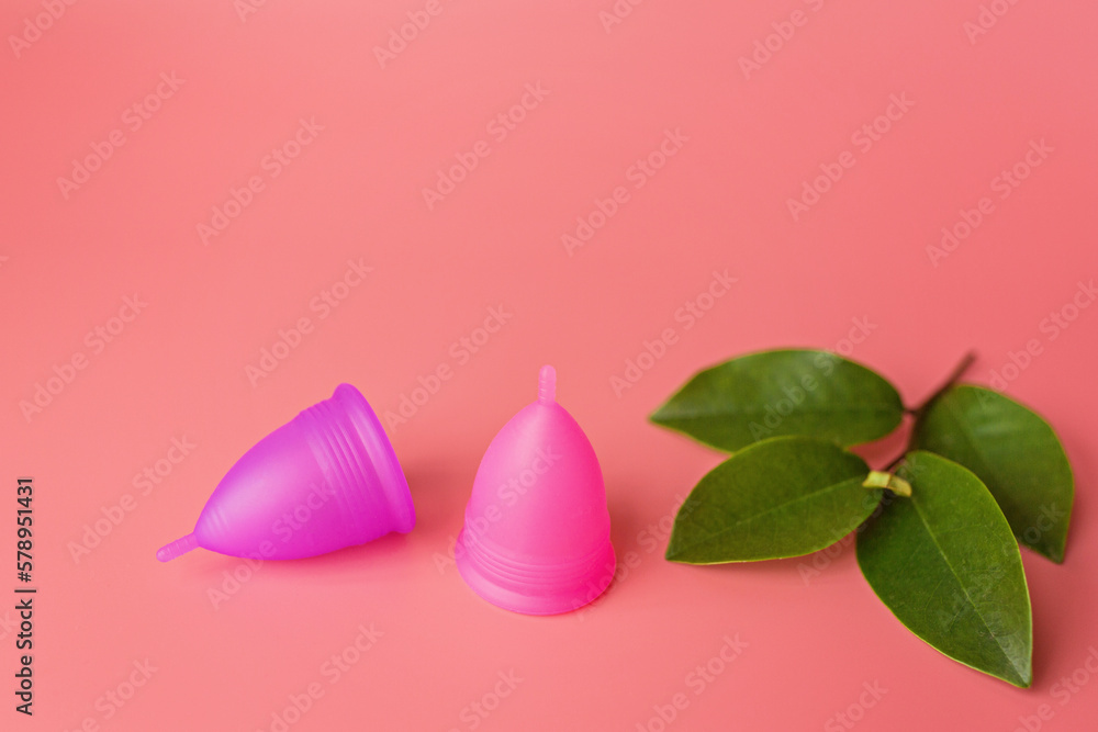 Menstrual cups on pink background. Alternative feminine hygiene product during the period. Women health concept. Copy space. Eco friendly concept, zero waste product. mockup, template Menstrual cups on pink background. Alternative feminine hygiene product during the period. Women health concept. Copy space. Eco friendly concept, zero waste product. mockup, template