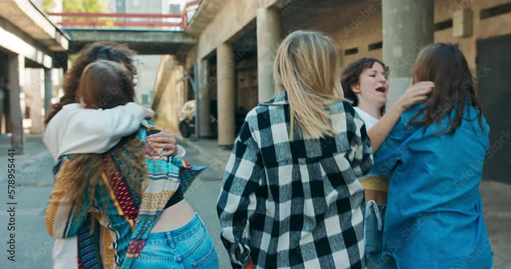 Happy friends girls meeting reunion on street hugging spend time together have fun relaxing resting after lessons at school. Breakdancers . Happy friends girls meeting reunion on street hugging spend time together have fun relaxing resting after lessons at school. Breakdancers .