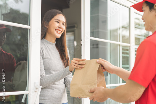 Postman, service fast food asian young woman, girl hand received order, delivery man, male holding, carrying paper bag send to customer house. Courier bring product, takeaway to door, express grocery.