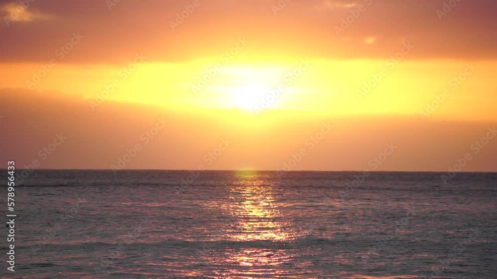 Blurred golden sea at sunset. The sun reflects and sparkles on the waves with bokeh, illuminating the golden sea. Holiday recreation concept. Abstract nautical summer ocean sunset nature background. Blurred golden sea at sunset. The sun reflects and sparkles on the waves with bokeh, illuminating the golden sea. Holiday recreation concept. Abstract nautical summer ocean sunset nature background.