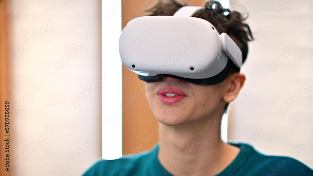 A young excited caucasian man taking off VR glasses in an office A young excited caucasian man taking off VR glasses in an office