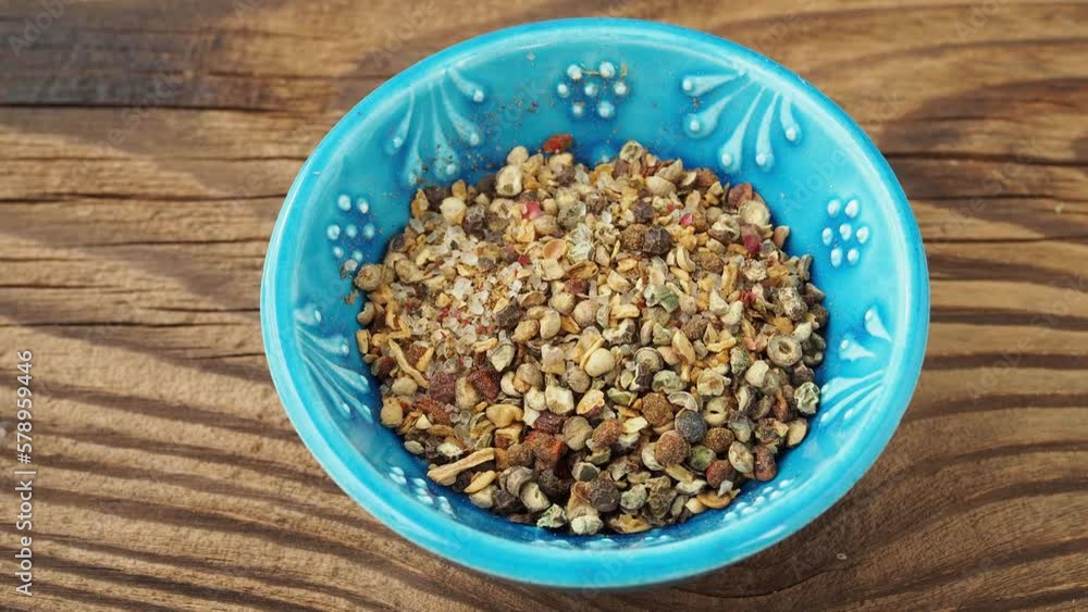 Colorful mixed pepper grains with crushed flakes in ceramic bowl Colorful mixed pepper grains with crushed flakes in ceramic bowl