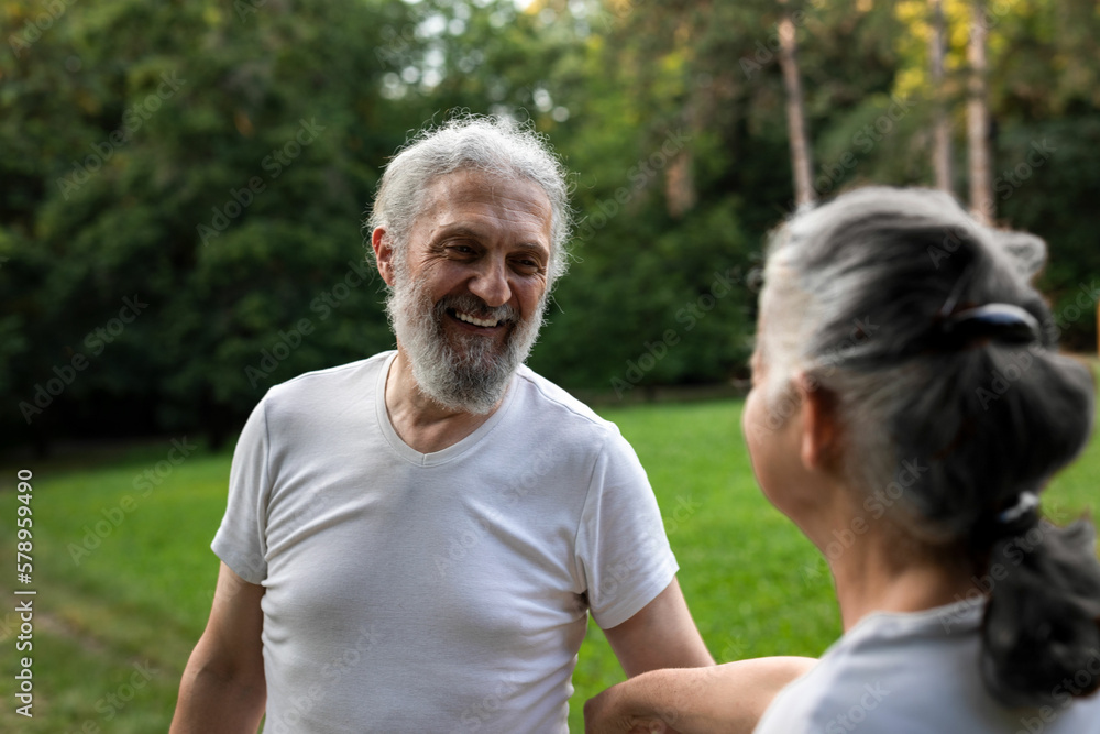 Senior man and woman are working out in the nature Senior man and woman are working out in the nature