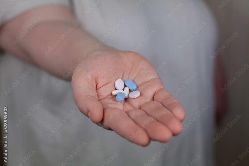 © Cavan Images - Woman Holding out Drugs © Cavan Images - Woman Holding out Drugs