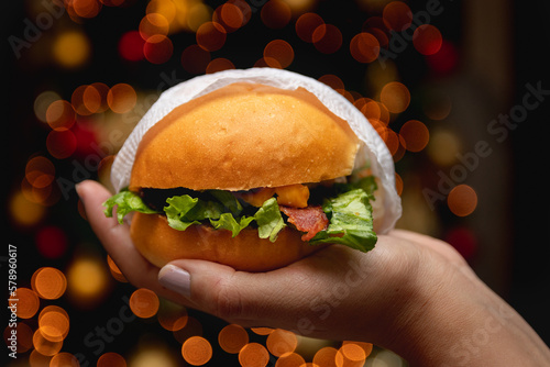 burger with bacon and cheese with cristmas tree background photo