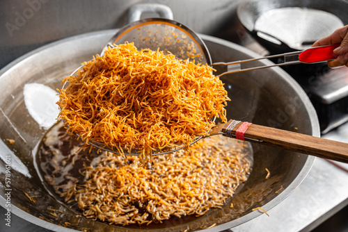 Making Proses Dried potato or potato mustofa (indonesian : Kering Kentang Potato Balado) is the term for dry match-shaped potatoes stir-fried with Indonesian spices. photo