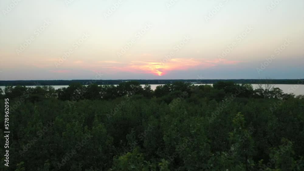 floatin over the trees on the shore of the Beautilful drone aerial fly over Seneca Lake New York at sunset floatin over the trees on the shore of the Beautilful drone aerial fly over Seneca Lake New York at sunset
