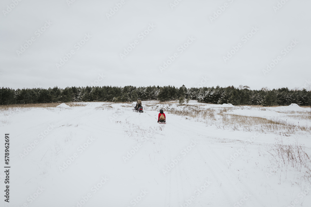 Snowmobiling and sledding in a field in northwestern Wisconsin Snowmobiling and sledding in a field in northwestern Wisconsin