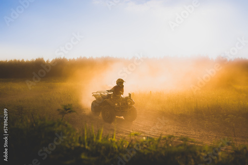 teen boy drifting atv 4 wheeler on dirt track in northwestern, wi photo