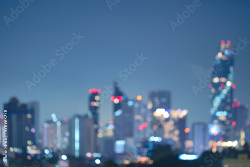 Abstract blurred background cityscape of Krung Thep Maha Nakhon (Bangkok) on night scene with multicolour bokeh from neon light on building 