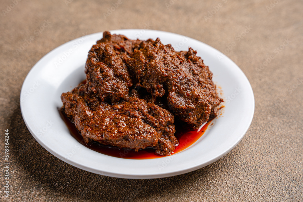 Beef Rendang is a Minang dish originating from the Minangkabau region in West Sumatra, Indonesia.  Rendang has been slow cooked and braised in a coconut milk seasoned with a herb and spice mixture