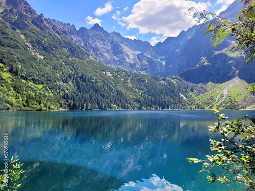 Beautiful photo of a mountain lake on a warm summer day. reflection of mountains in the water surface - the beauty of the power and strength of nature