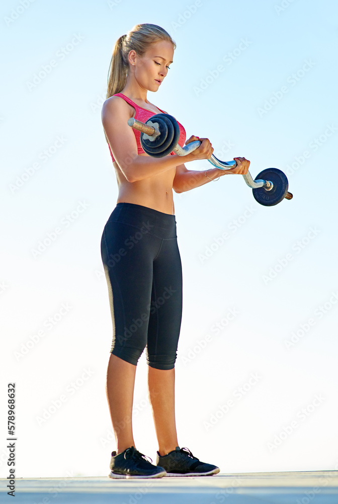 This is a piece of cake. Full length shot of a young woman working out with a barbell. This is a piece of cake. Full length shot of a young woman working out with a barbell.