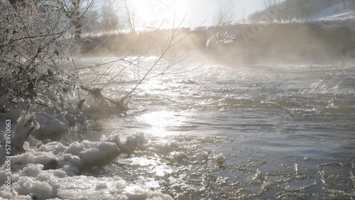 Mist over the frozen river Slow Motion, backlit in the early morning