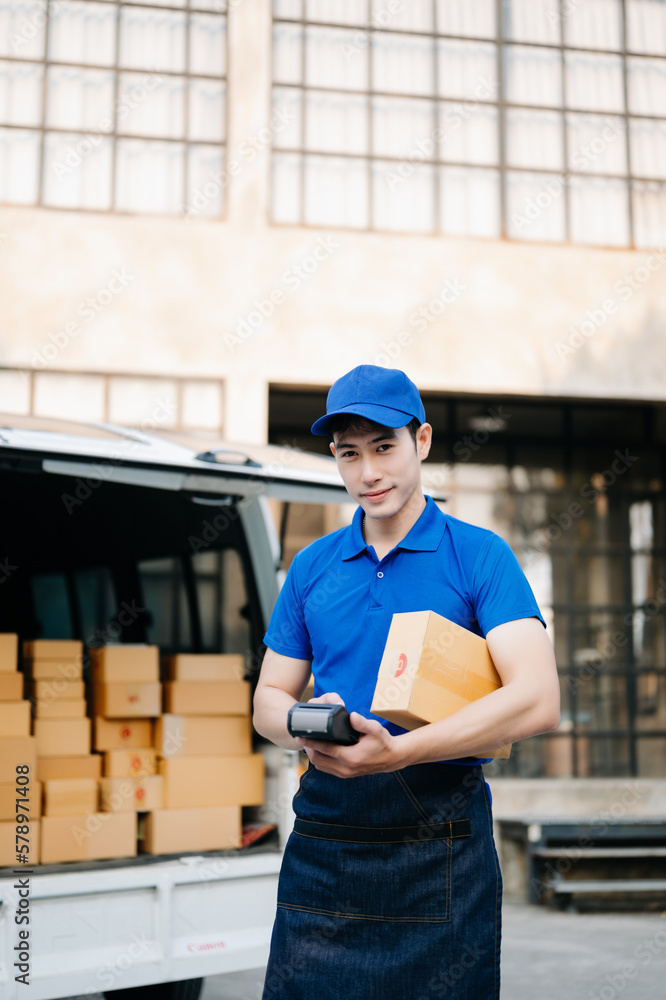 Happy delivery man standing with arms crossed near van outside the warehouse. This is a freight transportation and distribution warehouse. Happy delivery man standing with arms crossed near van outside the warehouse. This is a freight transportation and distribution warehouse.