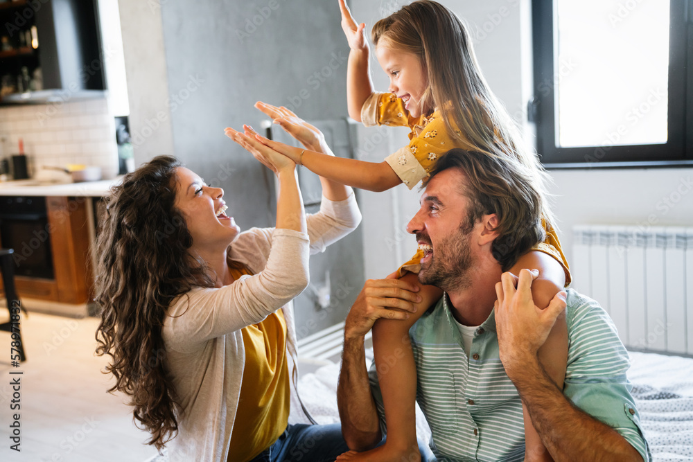 © NDABCREATIVITY - Happy family having fun time at home together. People love, happiness concept.