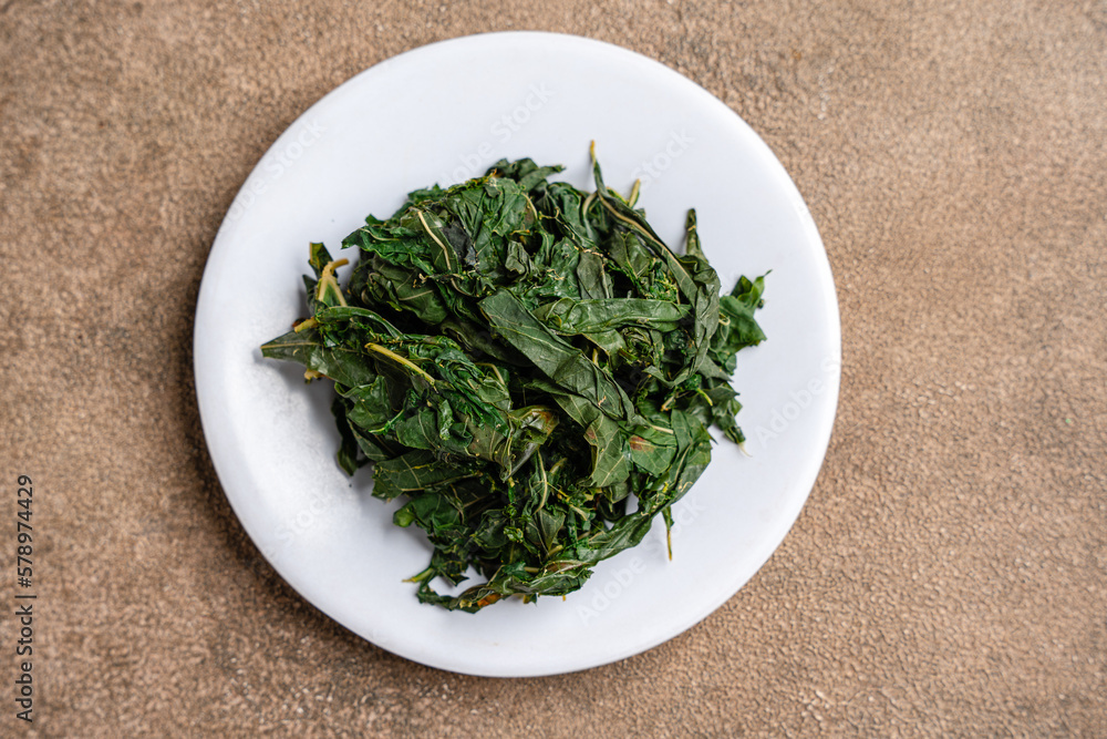 Daun ubi tumbuk or daun singkong tumbuk, made from pounded cassava leaves. usually served with (indonesian : nasi padang) Daun ubi tumbuk or daun singkong tumbuk, made from pounded cassava leaves. usually served with (indonesian : nasi padang)