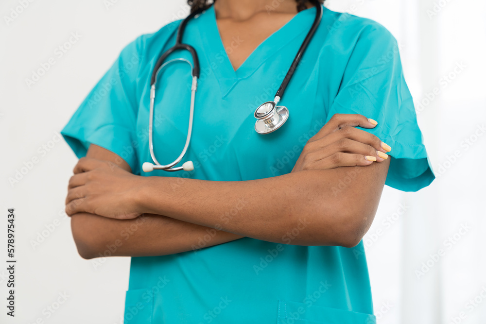 Female doctor wearing blue scrubs uniform and holding stethoscope on white background. Female nurse wear uniform and stethoscope at work. Healthcare and medicine concept Female doctor wearing blue scrubs uniform and holding stethoscope on white background. Female nurse wear uniform and stethoscope at work. Healthcare and medicine concept