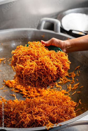 Making Proses Dried potato or potato mustofa (indonesian : Kering Kentang Potato Balado) is the term for dry match-shaped potatoes stir-fried with Indonesian spices. photo