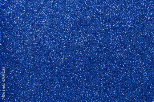 Abstract background filled with shiny dark blue glitter
