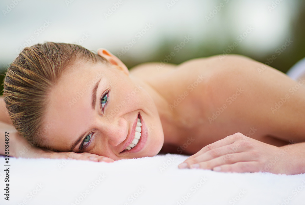 Fototapeta premium Letting go and finding total relaxation. Cropped portrait of a young woman lying on a massage table.