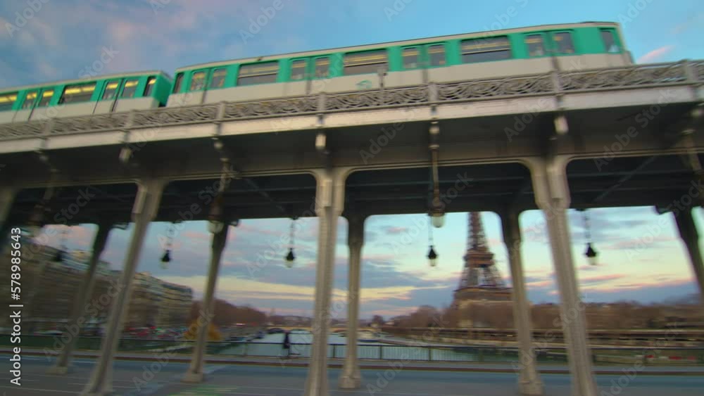 French old metro passes over the famous metal bridge in the center of Paris, near the eiffel tower French old metro passes over the famous metal bridge in the center of Paris, near the eiffel tower