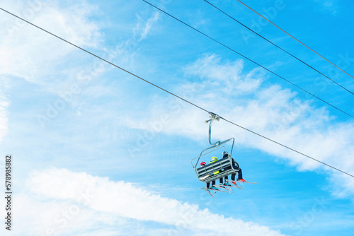 Ski Lift with a Group of Skiers against Blue Sky