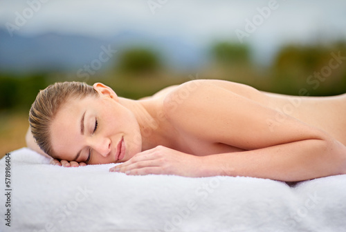 Lost in blissful and relaxing dreams. a young woman lying on a massage table.