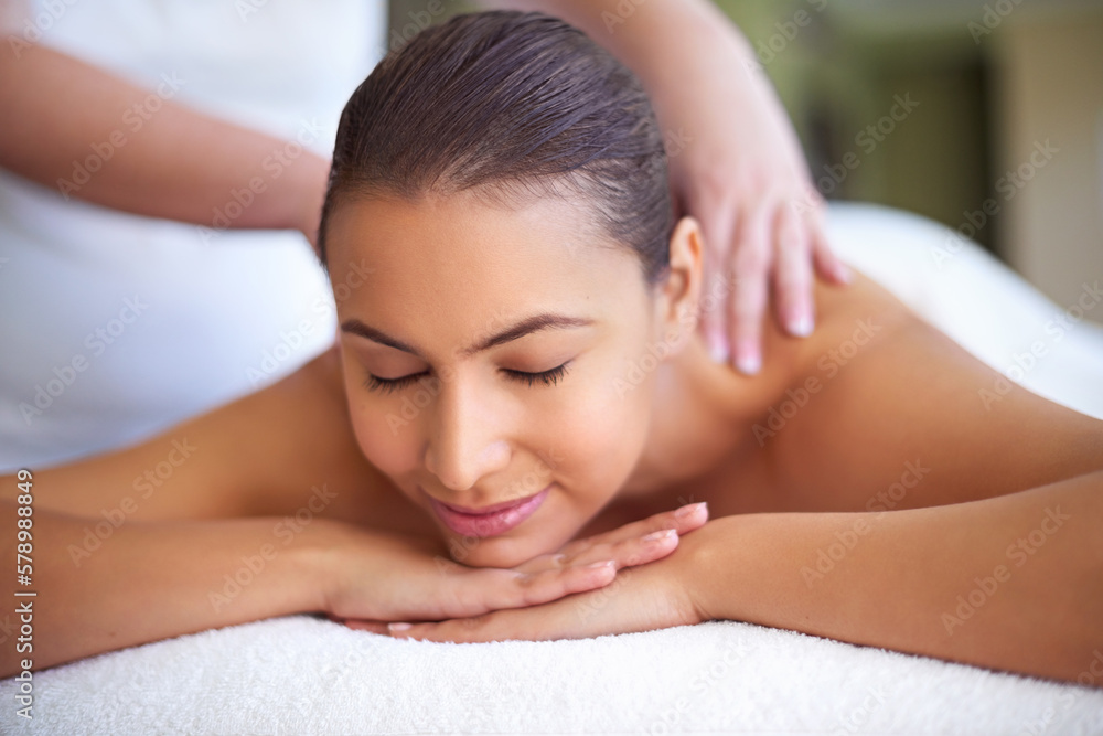 Let your troubles drift away. a young woman enjoying a back massage at a spa.