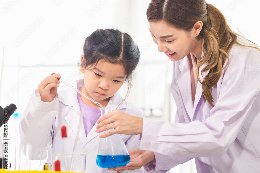 Elementary science class, Kid girl with teacher scientist in school laboratory, Science laboratory Elementary science class, Kid girl with teacher scientist in school laboratory, Science laboratory