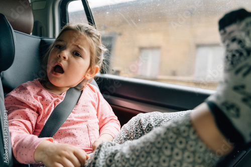 Happy child girl portrait in car seat 