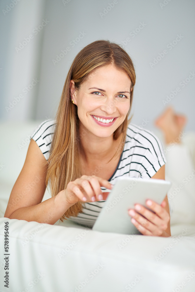 Connected and comfortable. a young woman browsing the internet at home. Connected and comfortable. a young woman browsing the internet at home.