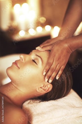 Massage therapy is the oldest form of medicine. Closeup shot of a young woman enjoying a head massage at the spa.