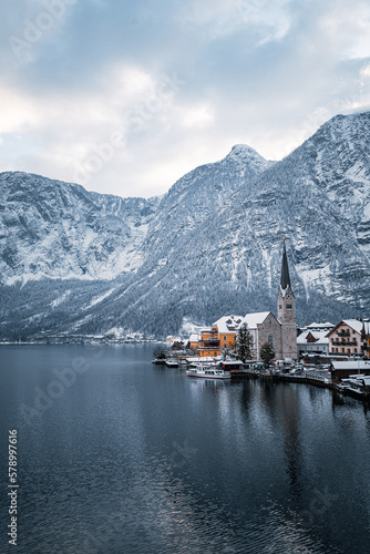 Hallstatt church in winter with mountains and the lake surrounding it. © Peter
