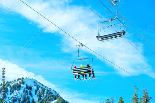 Skiers Enjoying the View in a Ski Lift
