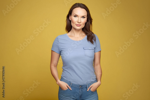 Beautiful caucasian girl standing on a yellow background looking at the camera. AI generative