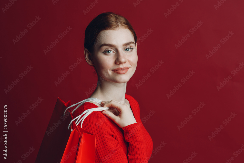 Pretty woman smilng portrait with paper red shopping bags. Black friday and sale concept Pretty woman smilng portrait with paper red shopping bags. Black friday and sale concept