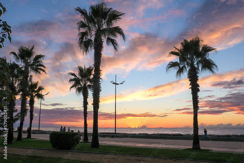 sunset ,sunrise on the beach. beautiful summer scenery. rocks on the sand. calm waves on the water. clouds on the sky. wide panoramic view